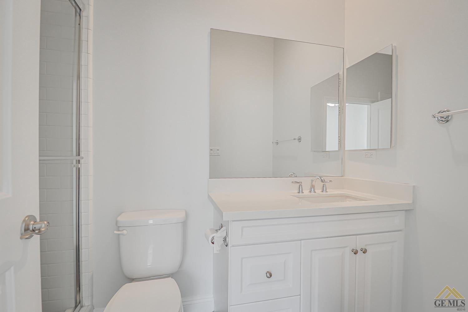 Undisclosed Address Bakersfield, CA 93311 - Photo 24 of 34 a bathroom with a toilet sink and mirror