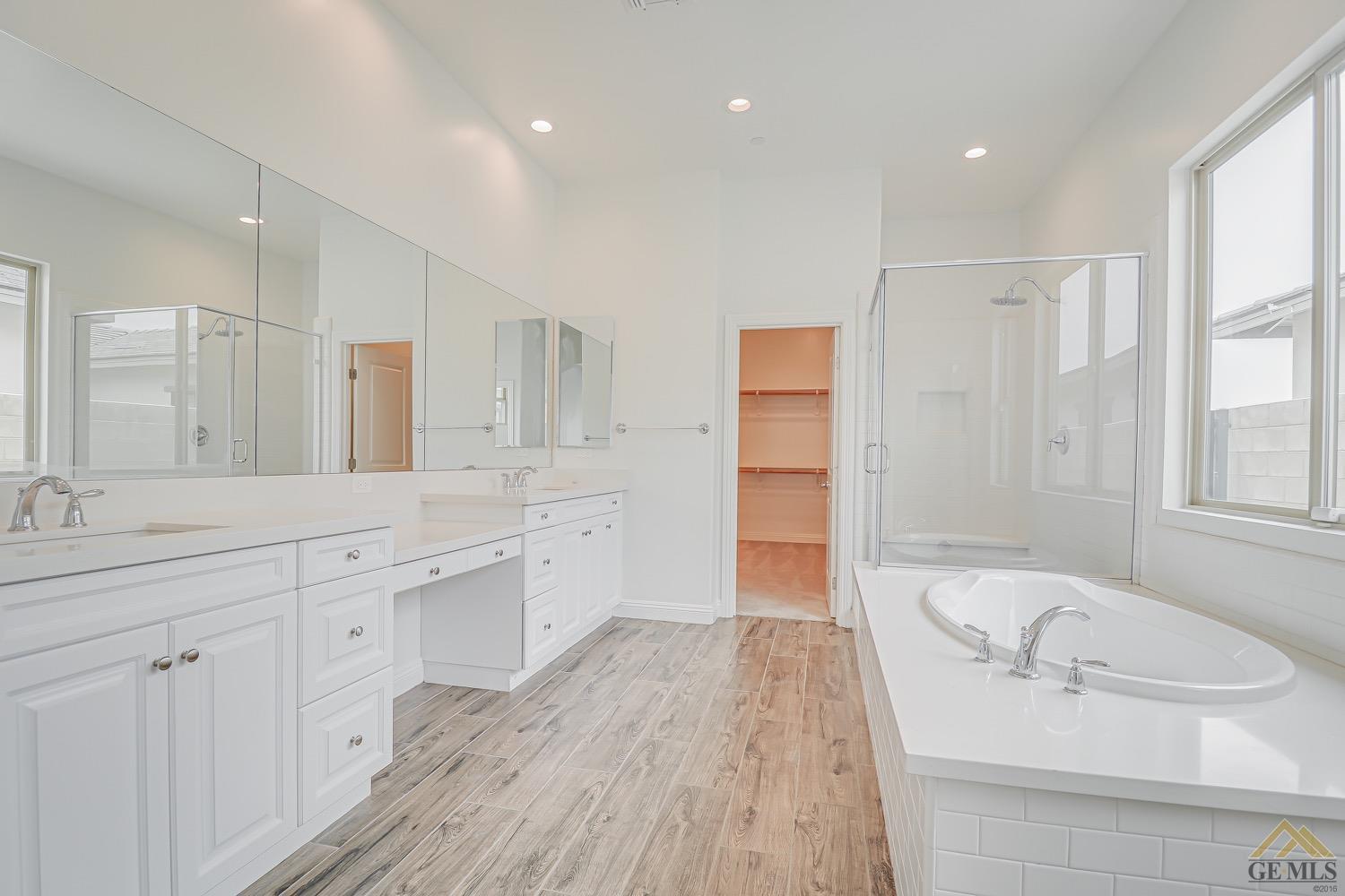 Undisclosed Address Bakersfield, CA 93311 - Photo 28 of 34 a spacious bathroom with a granite countertop sink mirror and a bathtub