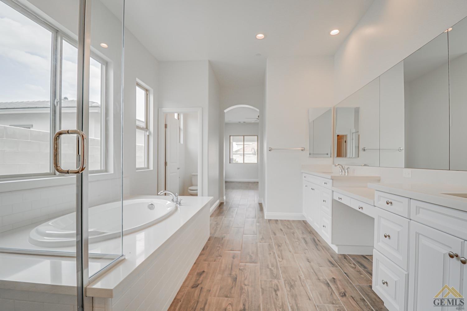 Undisclosed Address Bakersfield, CA 93311 - Photo 30 of 34 a spacious bathroom with a tub shower and sink