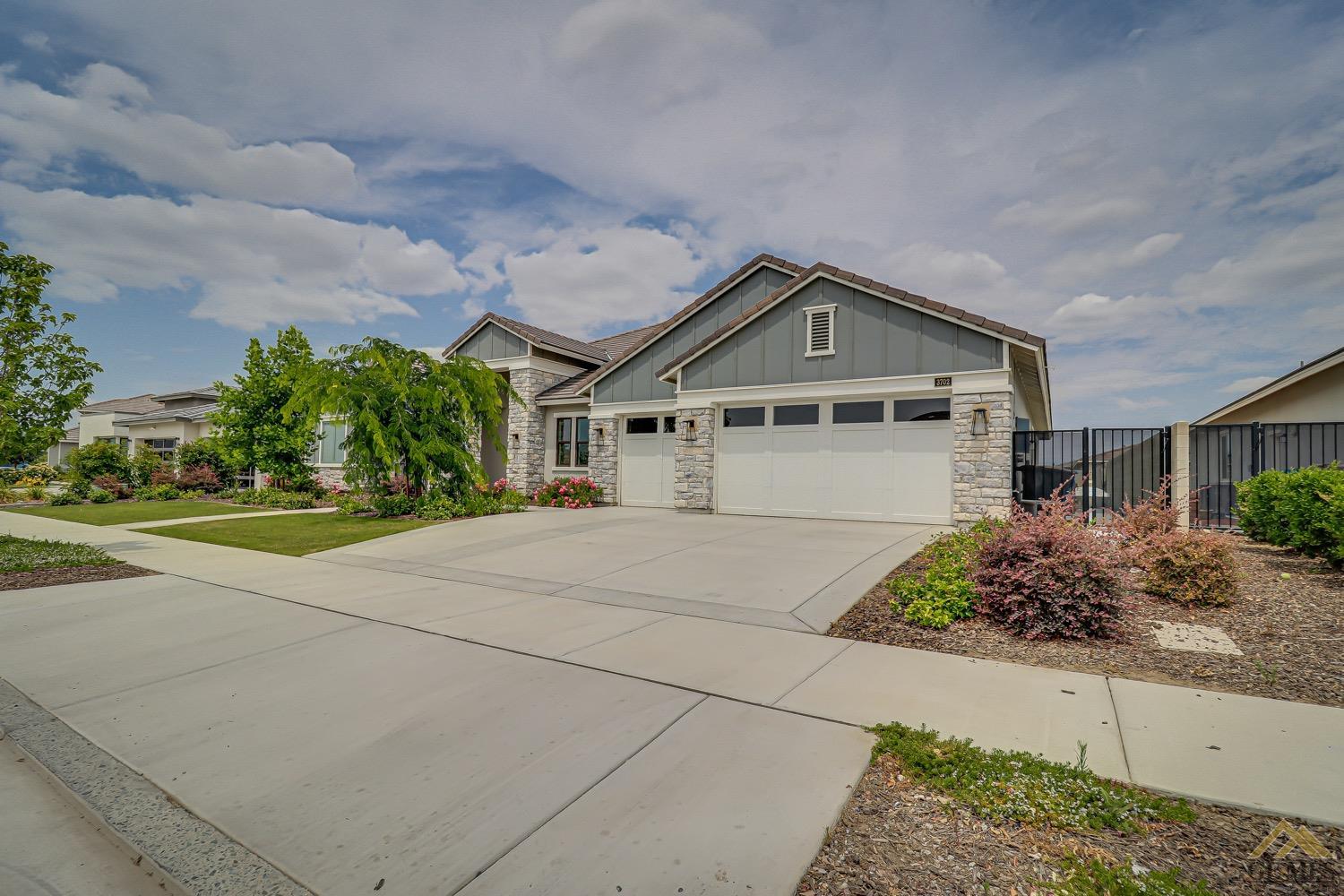 Undisclosed Address Bakersfield, CA 93311 - Photo 3 of 34 a front view of a house with garden