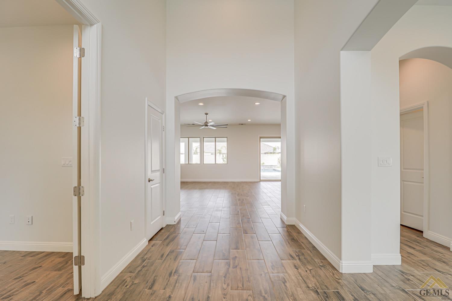 Undisclosed Address Bakersfield, CA 93311 - Photo 9 of 34 a view of empty room with wooden floor