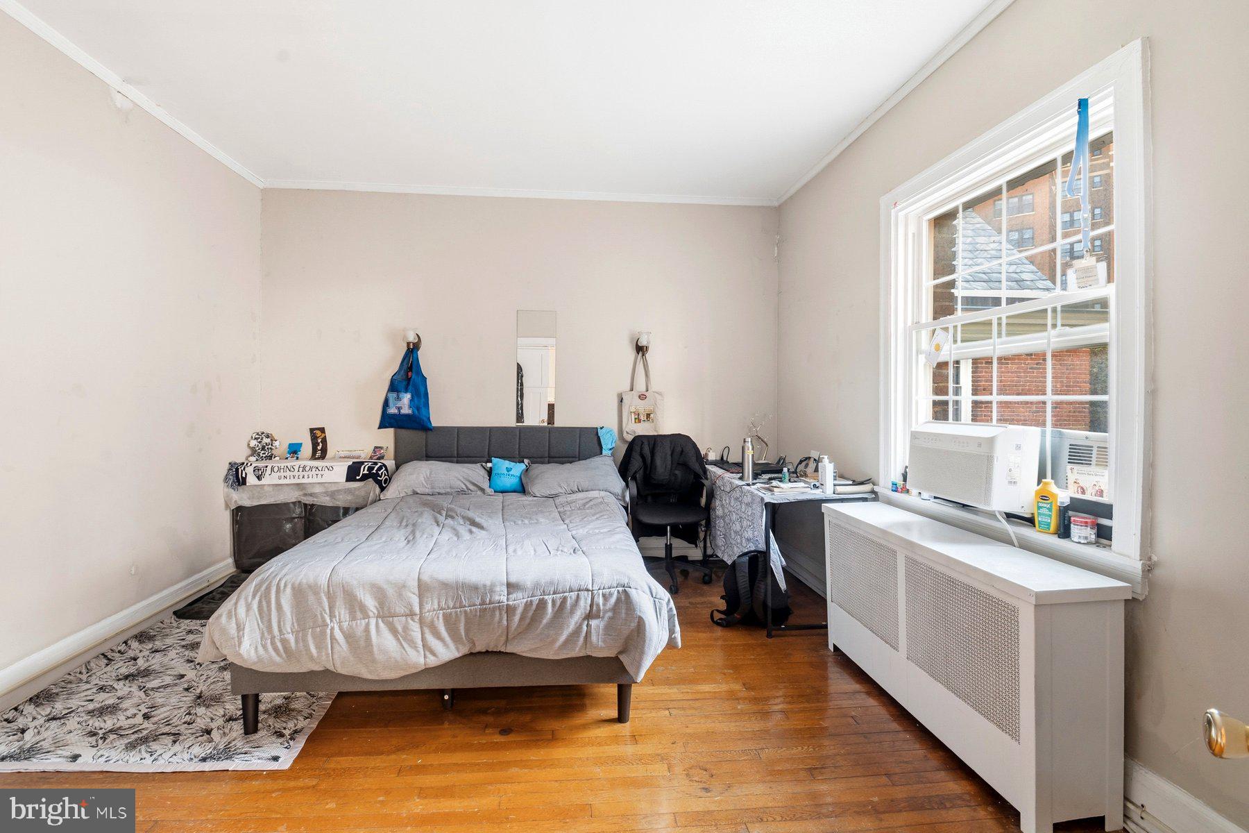 101 West 39th Street, Unit C3 Baltimore, MD 21210 - Photo 11 of 28 a bed room with a bed window and a table