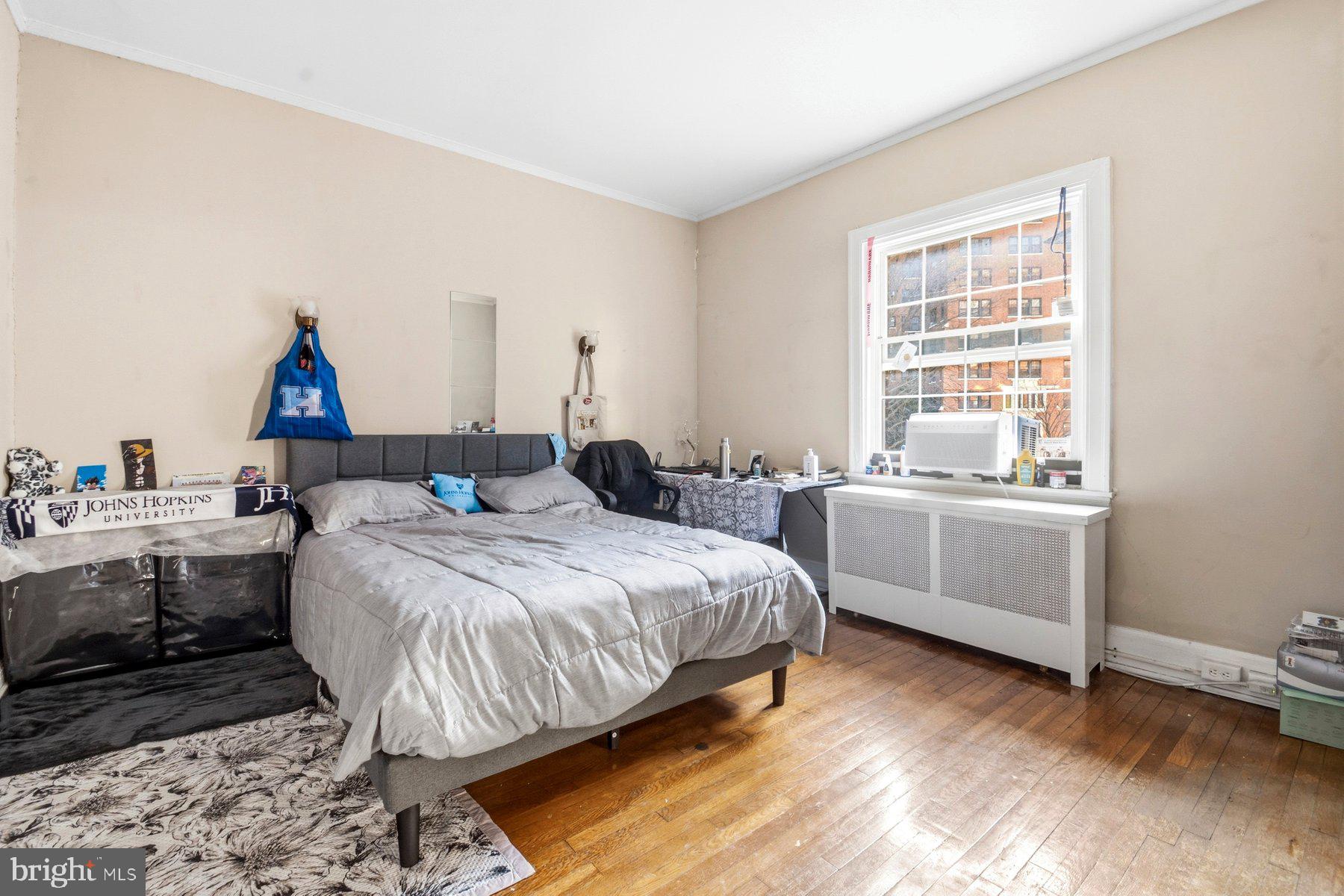 101 West 39th Street, Unit C3 Baltimore, MD 21210 - Photo 12 of 28 a bed room with a bed and a window