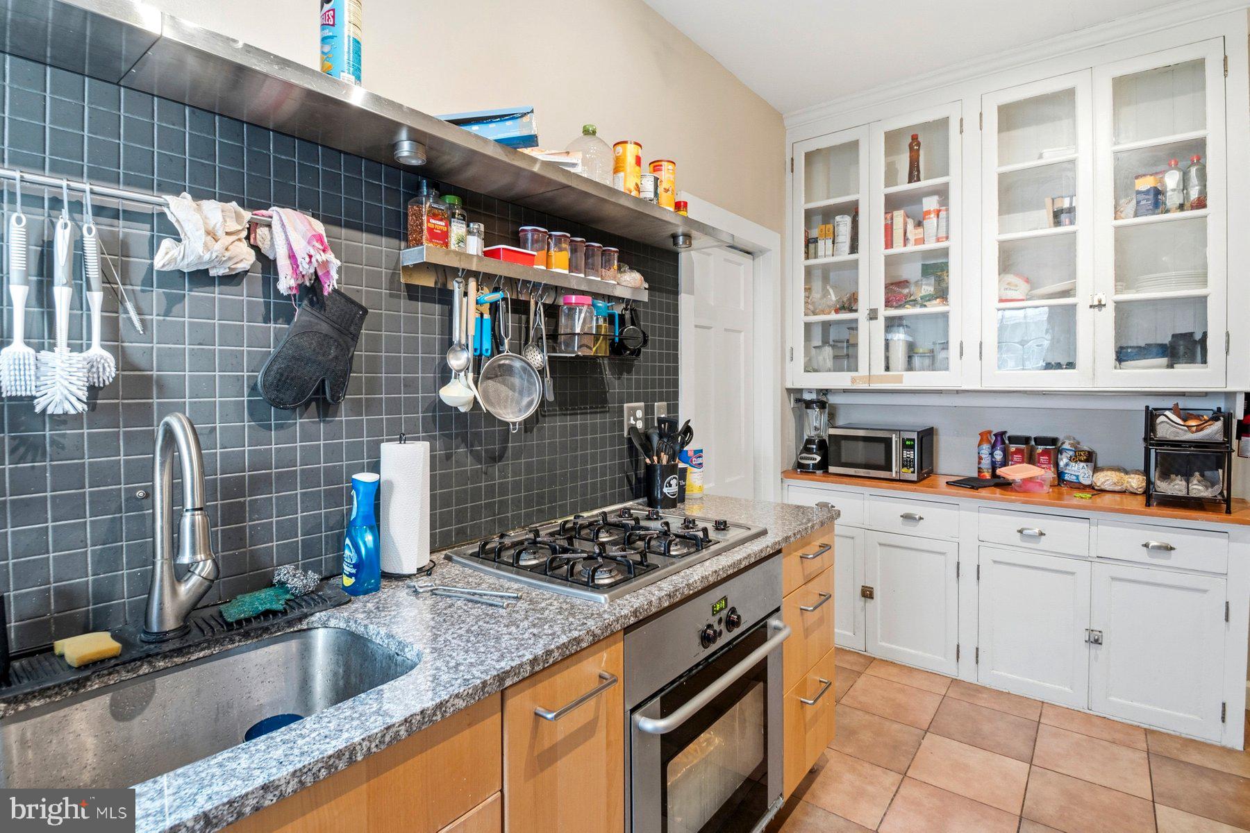 101 West 39th Street, Unit C3 Baltimore, MD 21210 - Photo 16 of 28 a kitchen with stainless steel appliances granite countertop a sink and cabinets