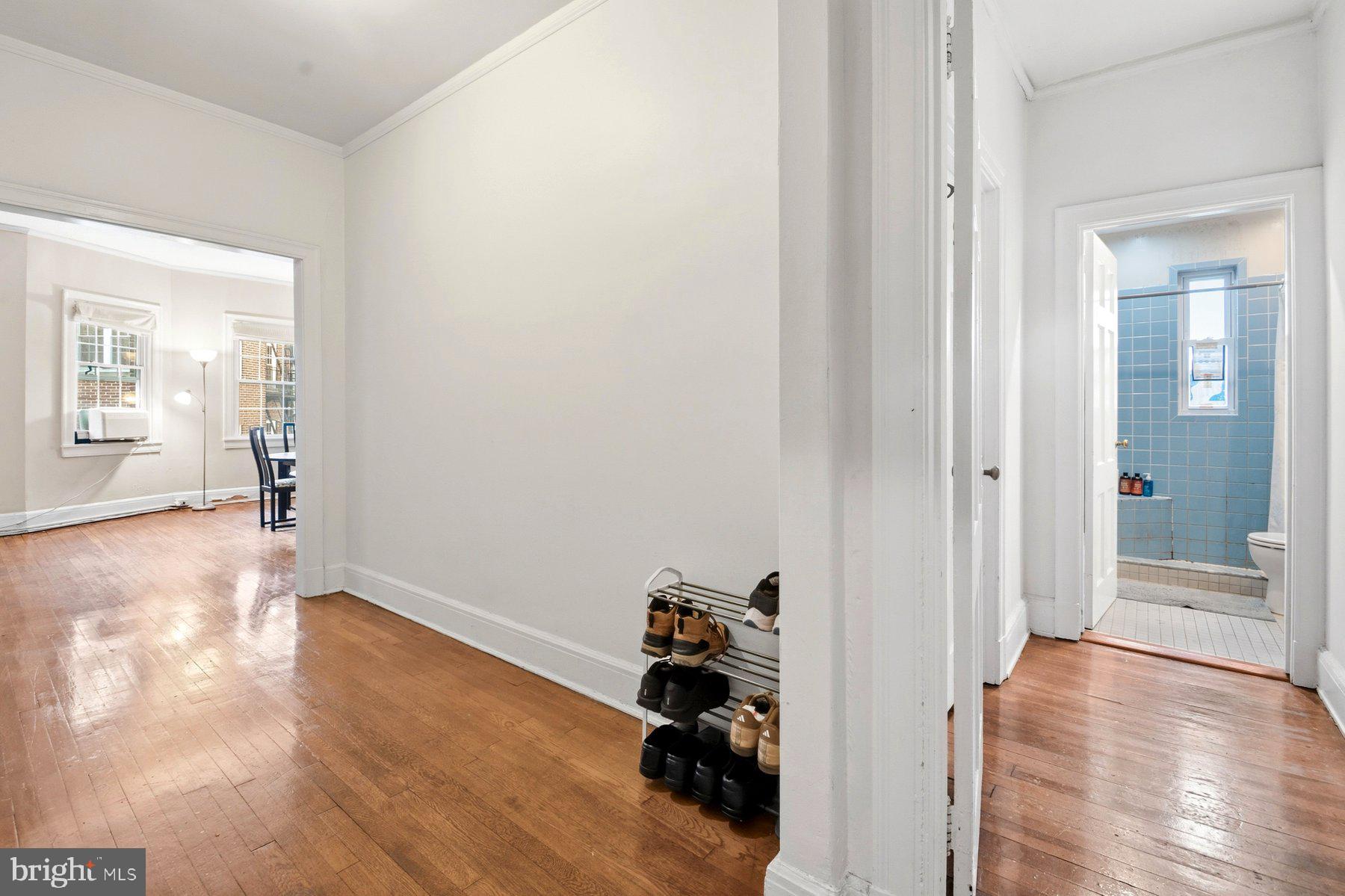 101 West 39th Street, Unit C3 Baltimore, MD 21210 - Photo 17 of 28 a view of a hallway with wooden floor and a living room
