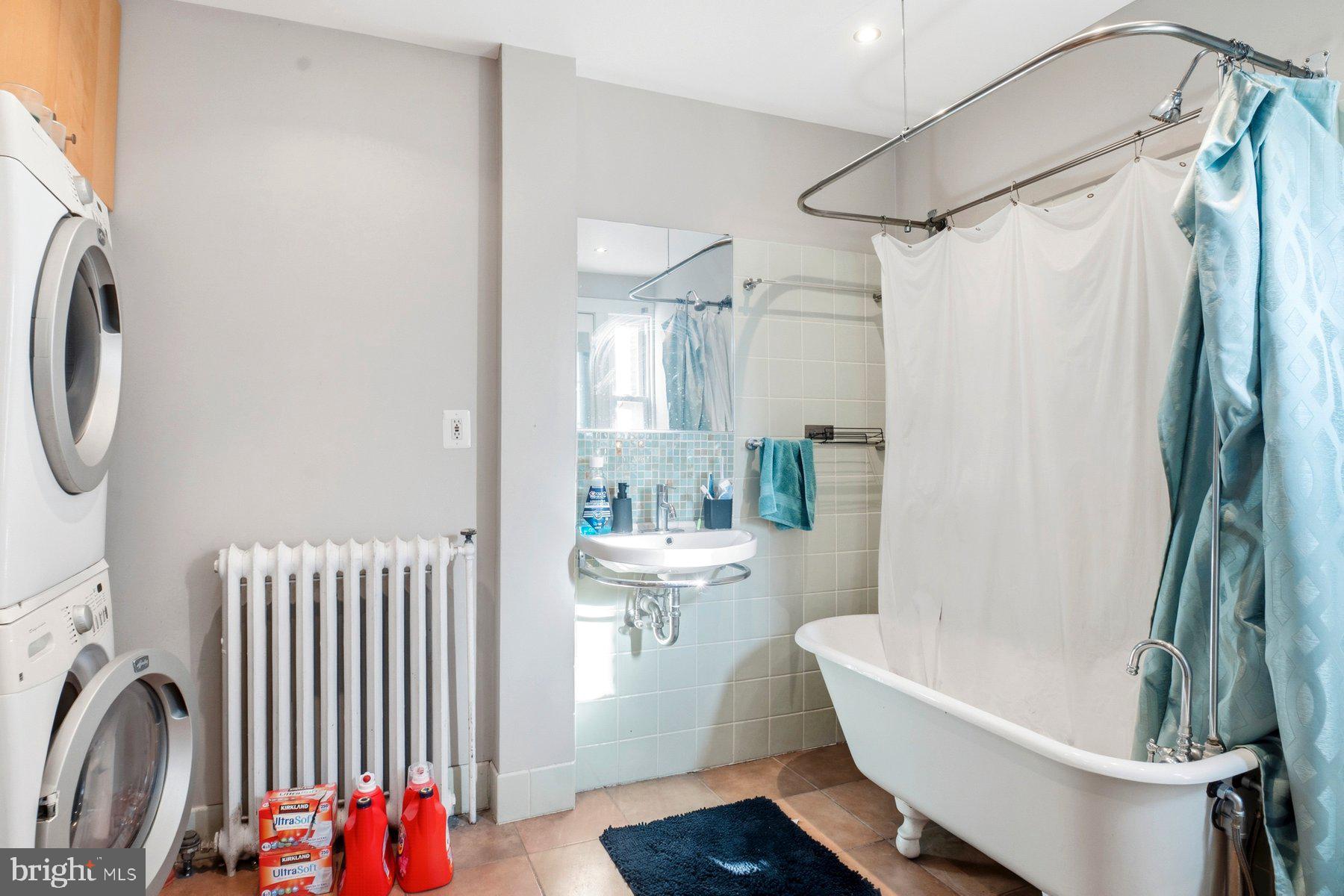 101 West 39th Street, Unit C3 Baltimore, MD 21210 - Photo 18 of 28 a bathroom with a sink a bathtub and a shower