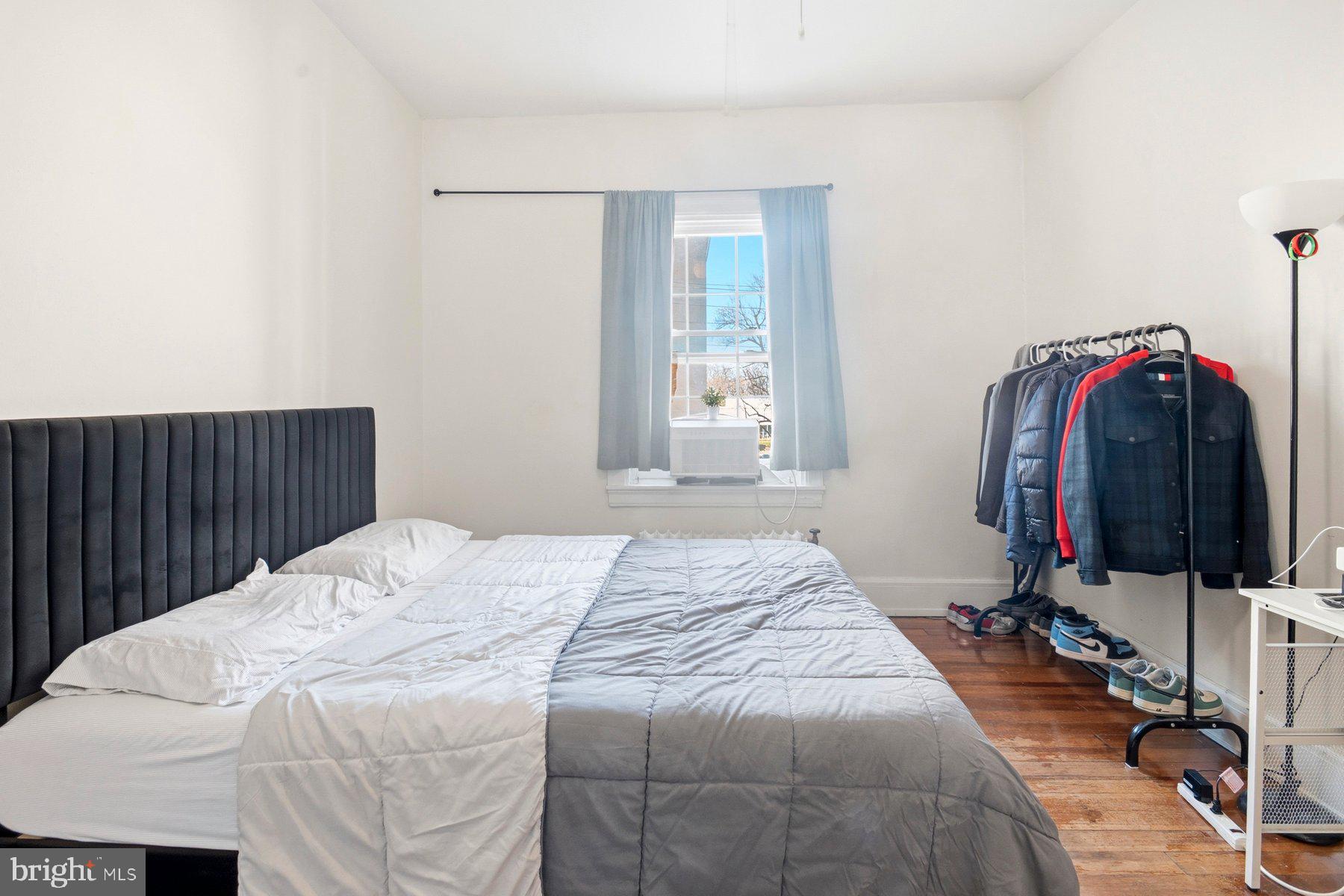 101 West 39th Street, Unit C3 Baltimore, MD 21210 - Photo 21 of 28 a bed sitting in a bedroom next to a window