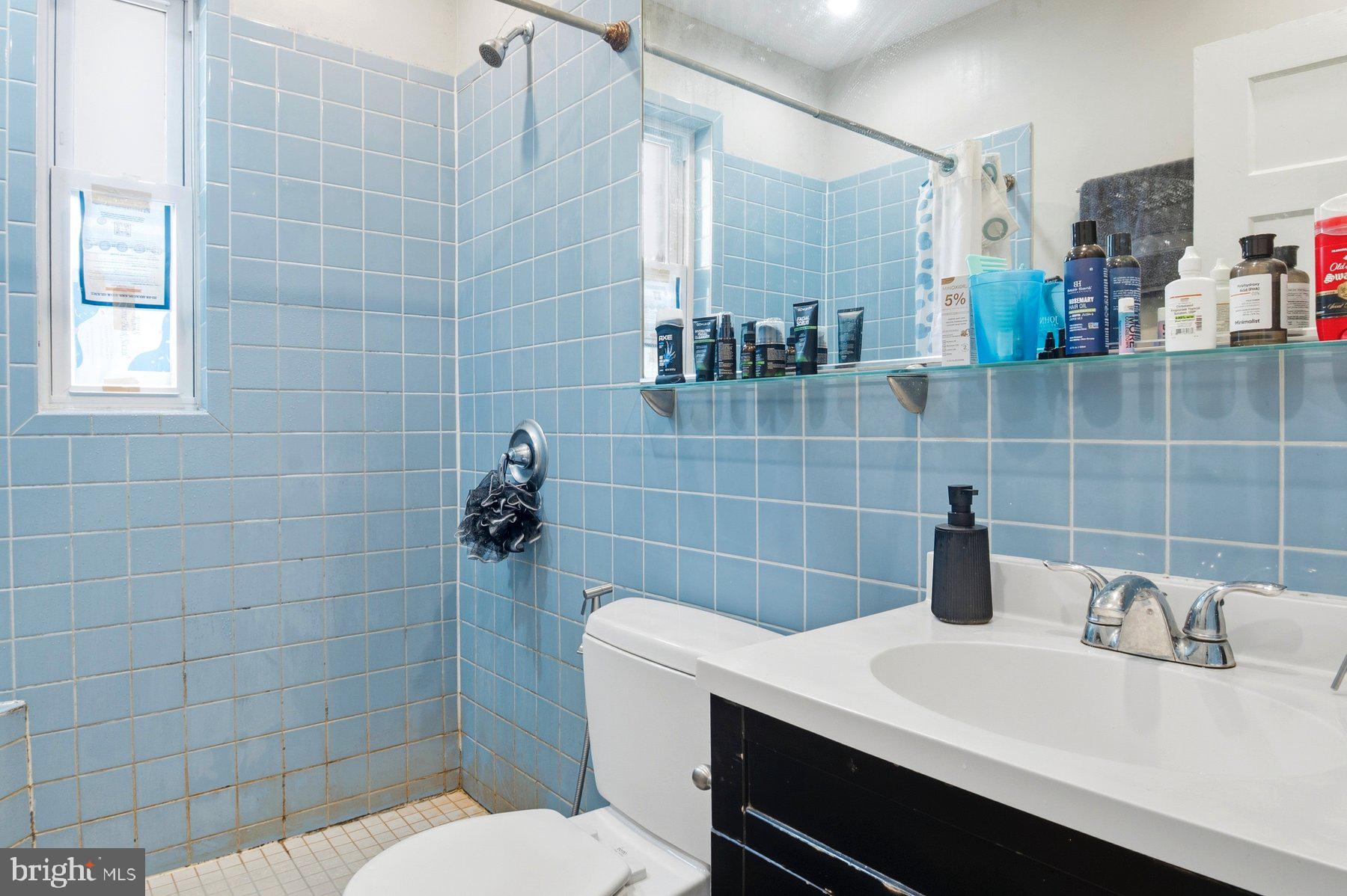 101 West 39th Street, Unit C3 Baltimore, MD 21210 - Photo 22 of 28 a bathroom with a sink a toilet and shower