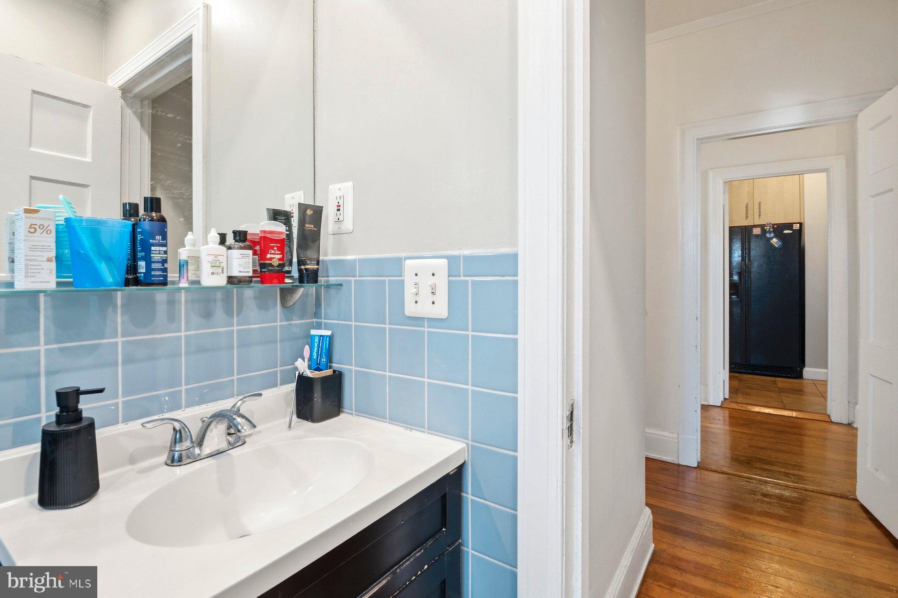 101 West 39th Street, Unit C3 Baltimore, MD 21210 - Photo 23 of 28 a bathroom with a sink and a mirror