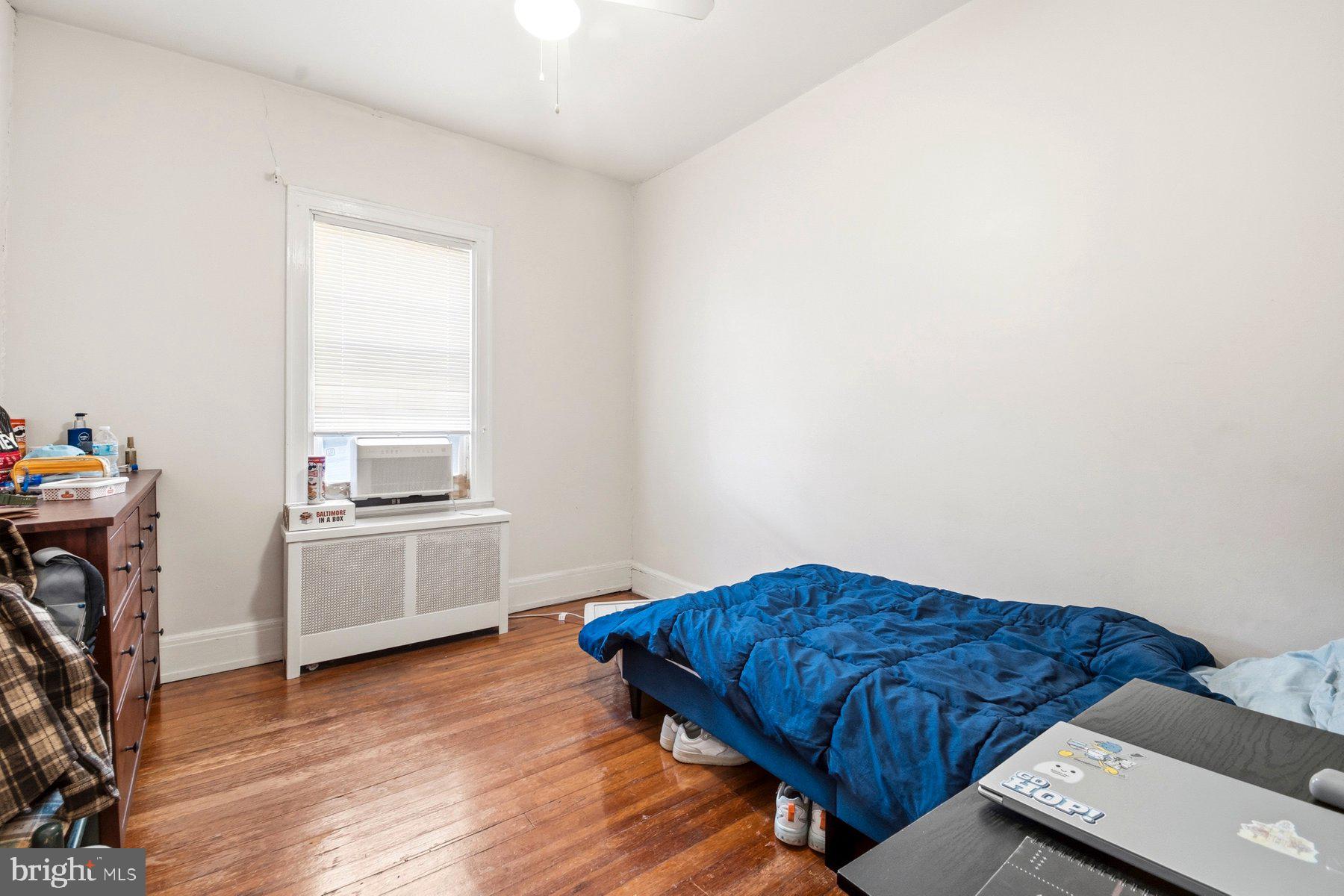 101 West 39th Street, Unit C3 Baltimore, MD 21210 - Photo 24 of 28 a living room with a bed and a stove top oven