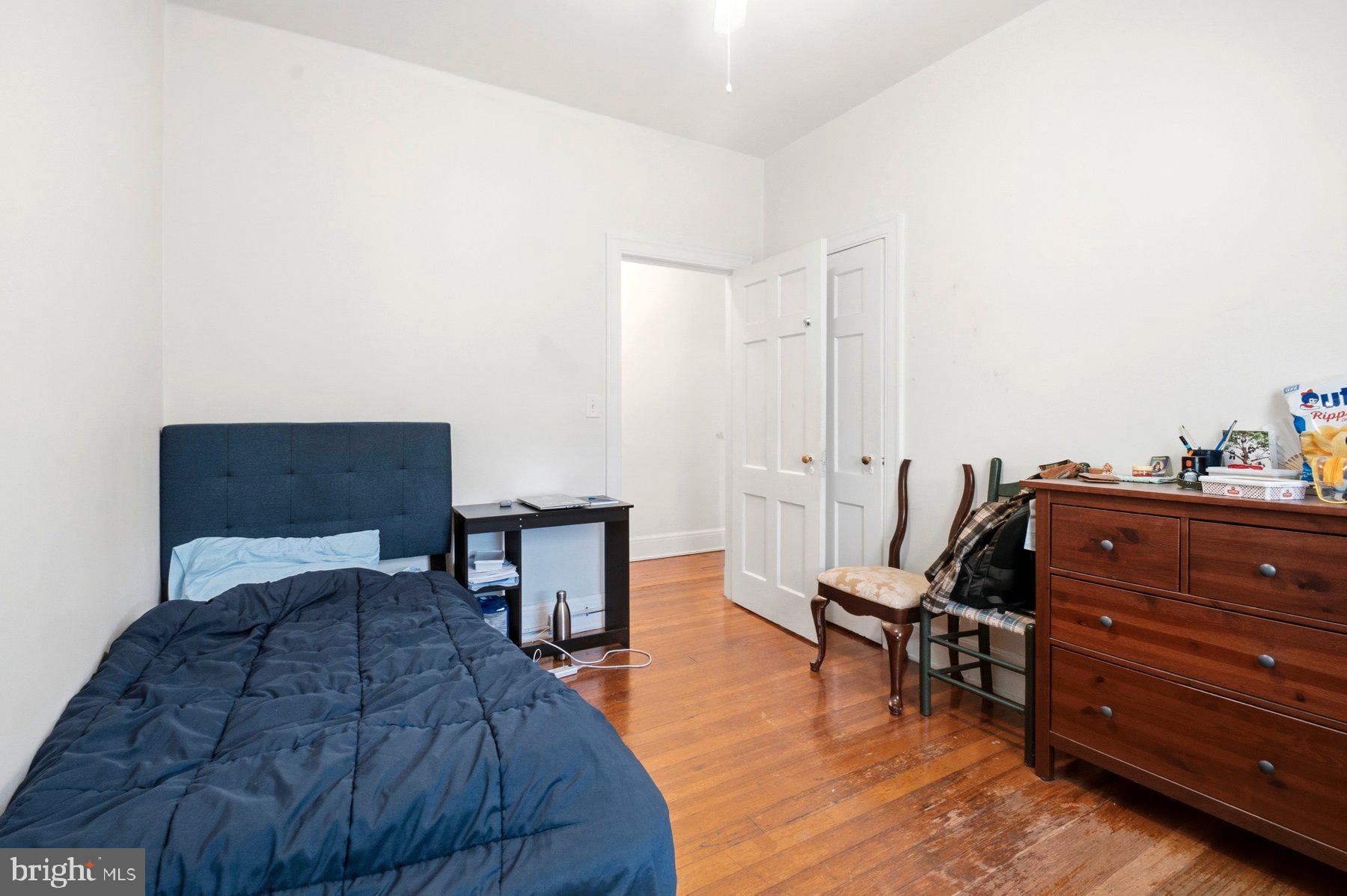 101 West 39th Street, Unit C3 Baltimore, MD 21210 - Photo 25 of 28 a bedroom with a bed and a chair