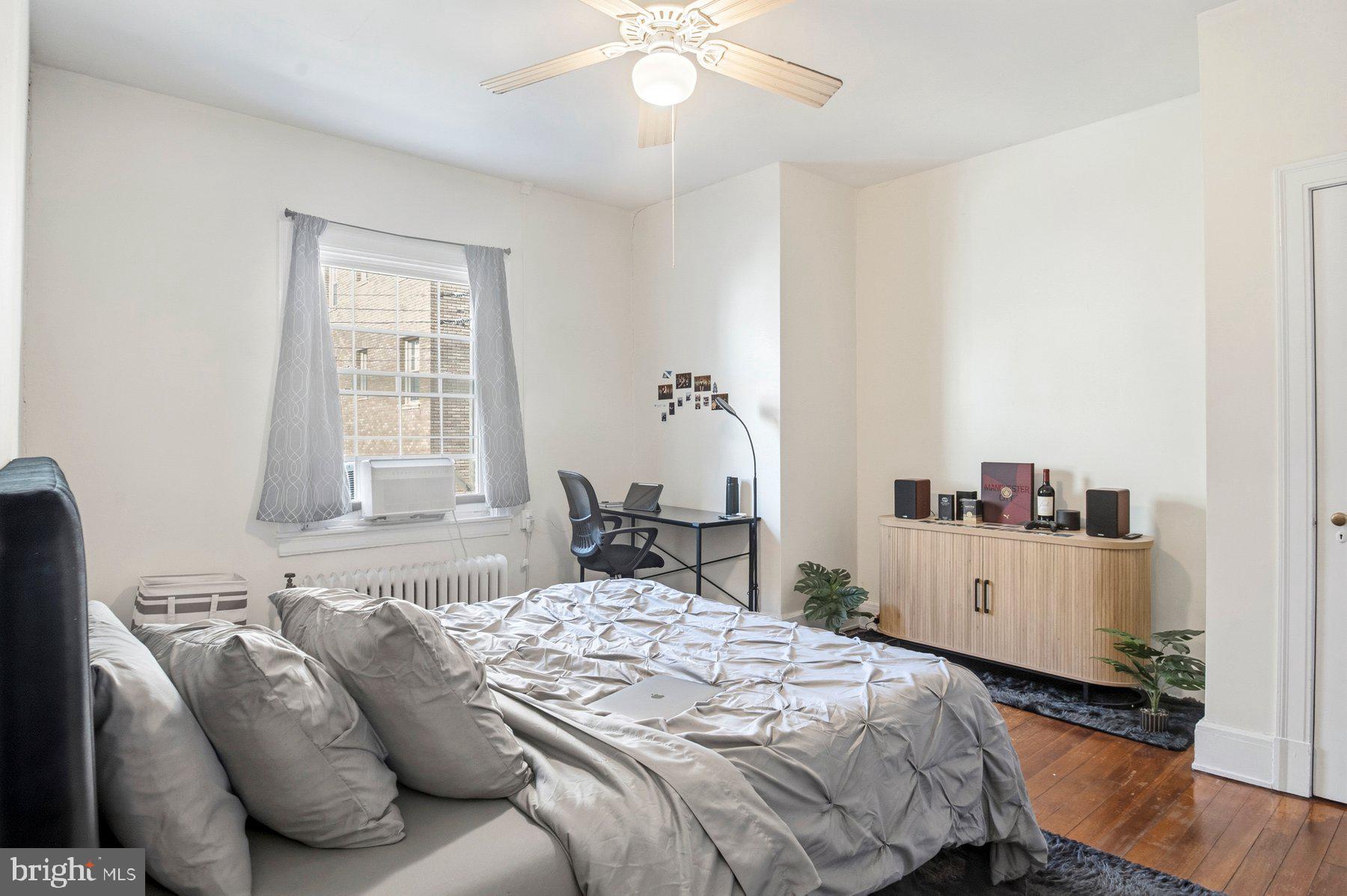 101 West 39th Street, Unit C3 Baltimore, MD 21210 - Photo 26 of 28 a bedroom with a bed and a chandelier