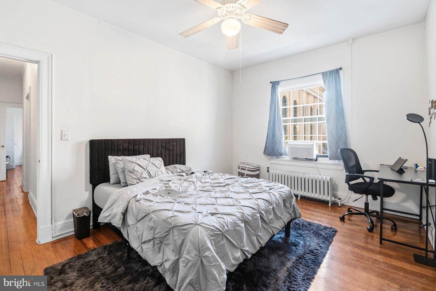 101 West 39th Street, Unit C3 Baltimore, MD 21210 - Photo 27 of 28 a bedroom with a bed and wooden floor