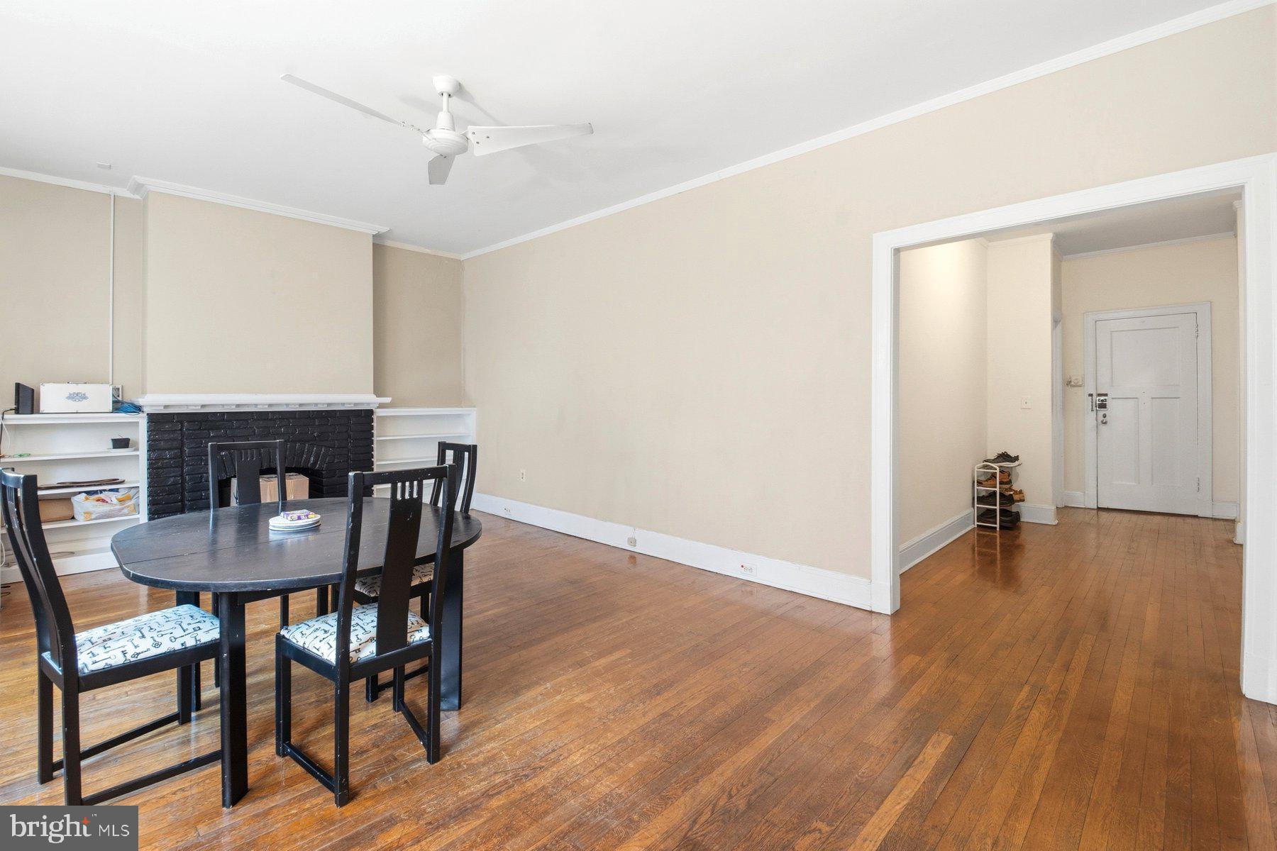 101 West 39th Street, Unit C3 Baltimore, MD 21210 - Photo 6 of 28 a view of a dining room with furniture and wooden floor