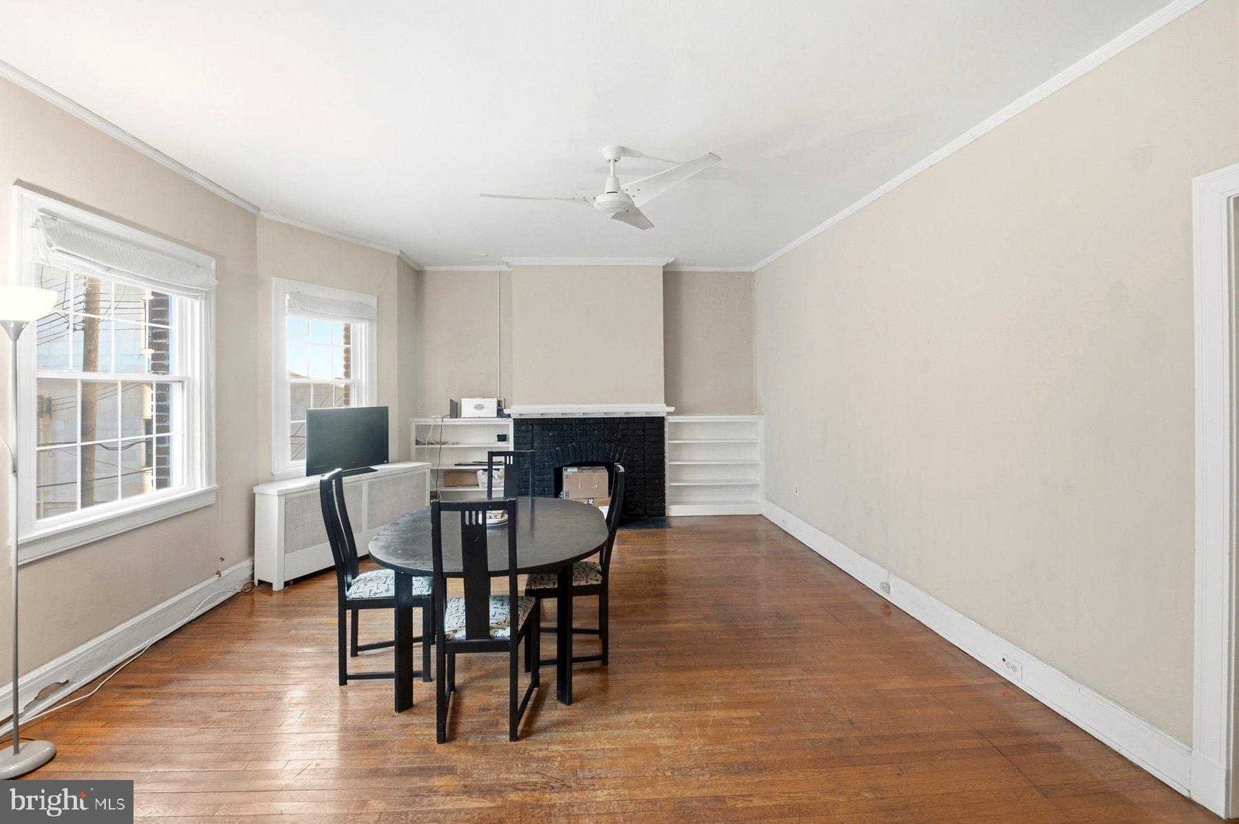 101 West 39th Street, Unit C3 Baltimore, MD 21210 - Photo 7 of 28 a view of a dining room with furniture and wooden floor