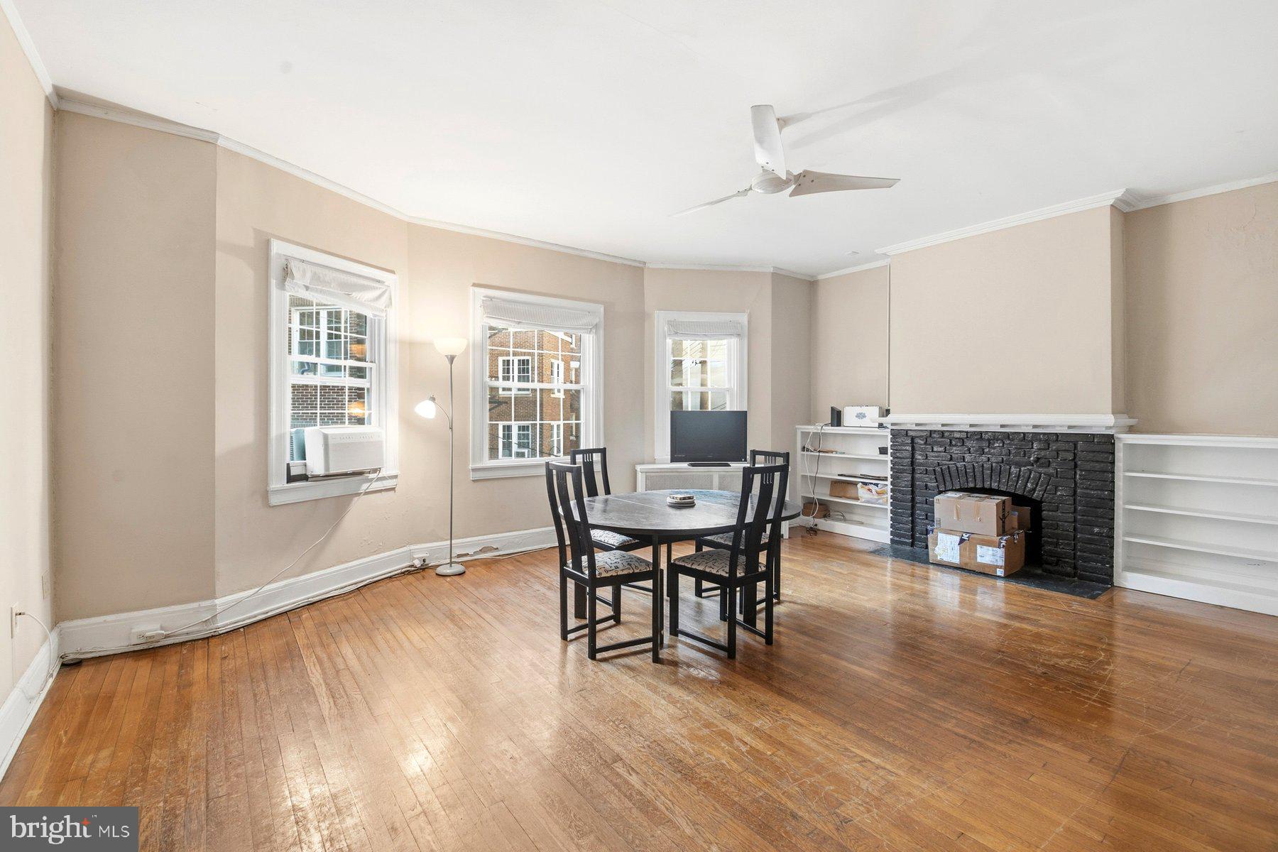 101 West 39th Street, Unit C3 Baltimore, MD 21210 - Photo 8 of 28 a dining room with furniture a fireplace and wooden floor