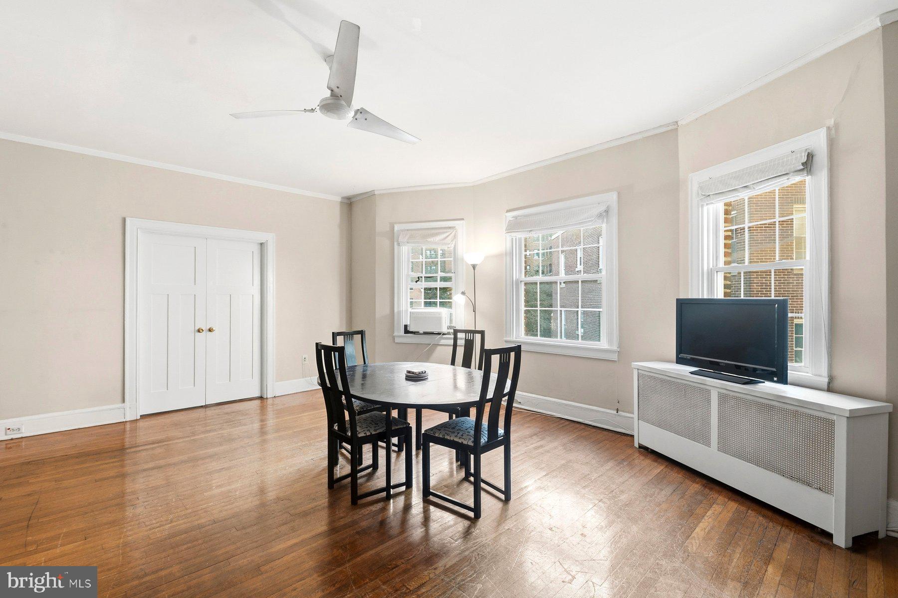 101 West 39th Street, Unit C3 Baltimore, MD 21210 - Photo 9 of 28 a view of a dining room with furniture window and wooden floor