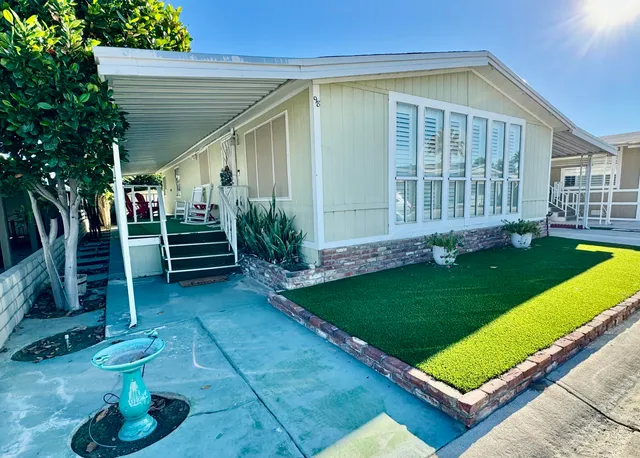 a view of a house with backyard and sitting area