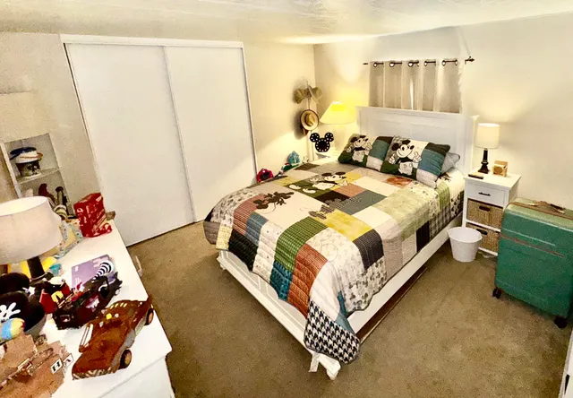 a bedroom with a bed and a mirror