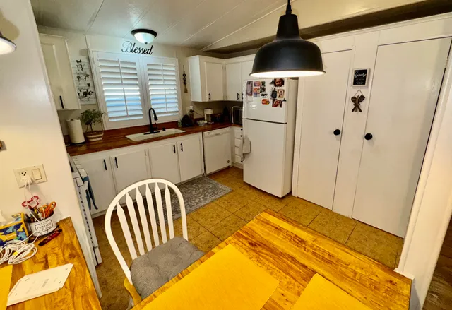 a kitchen with a refrigerator and a sink