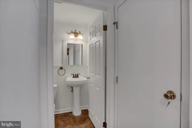 a bathroom with a sink and mirror with toilet