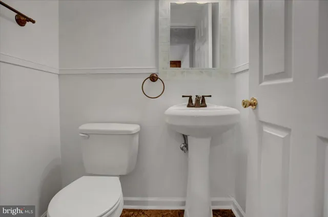 a bathroom with a sink mirror toilet and vanity