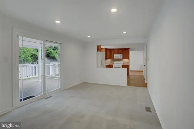 a view of a kitchen with a refrigerator a microwave and a sink