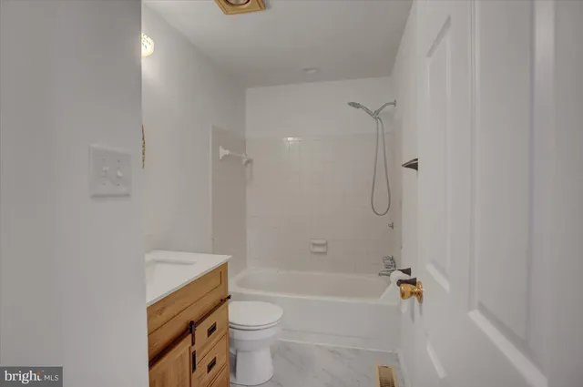 a bathroom with a bathtub toilet and sink