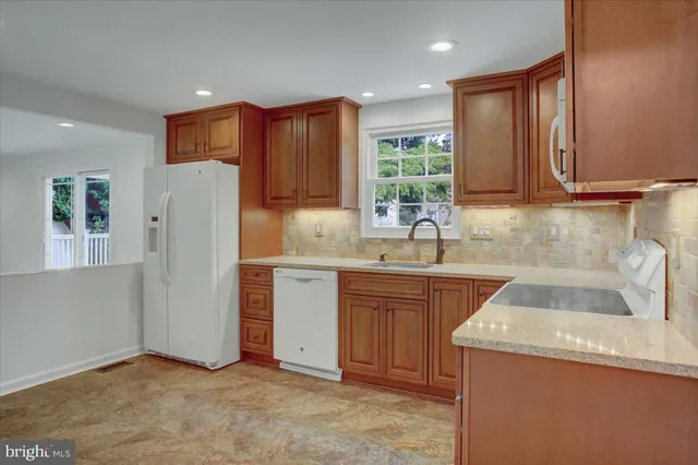 a kitchen with refrigerator and sink