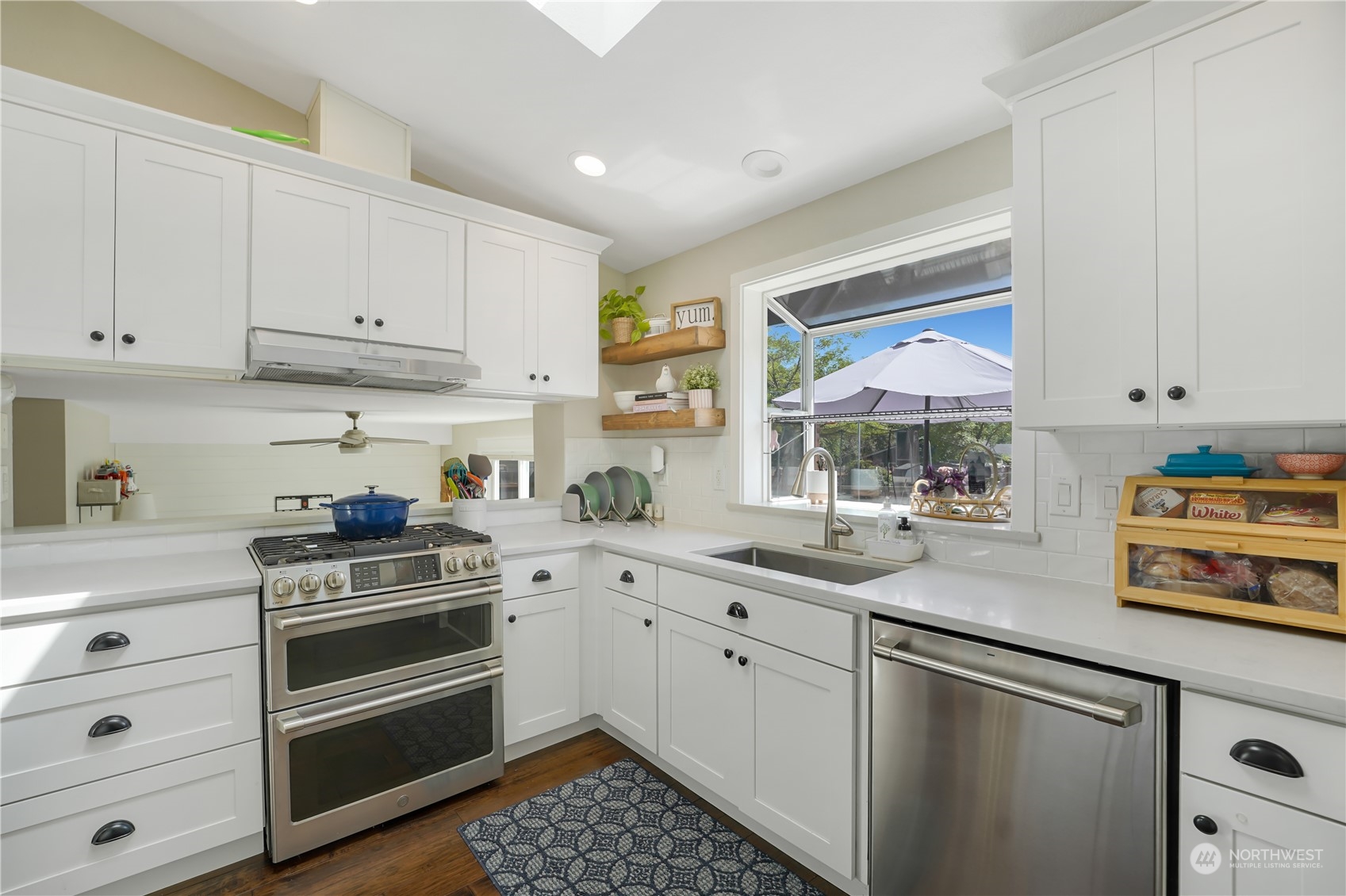 1410 220th Street Southwest Bothell, WA 98021 - Photo 12 of 25 a kitchen with a sink stove and cabinets