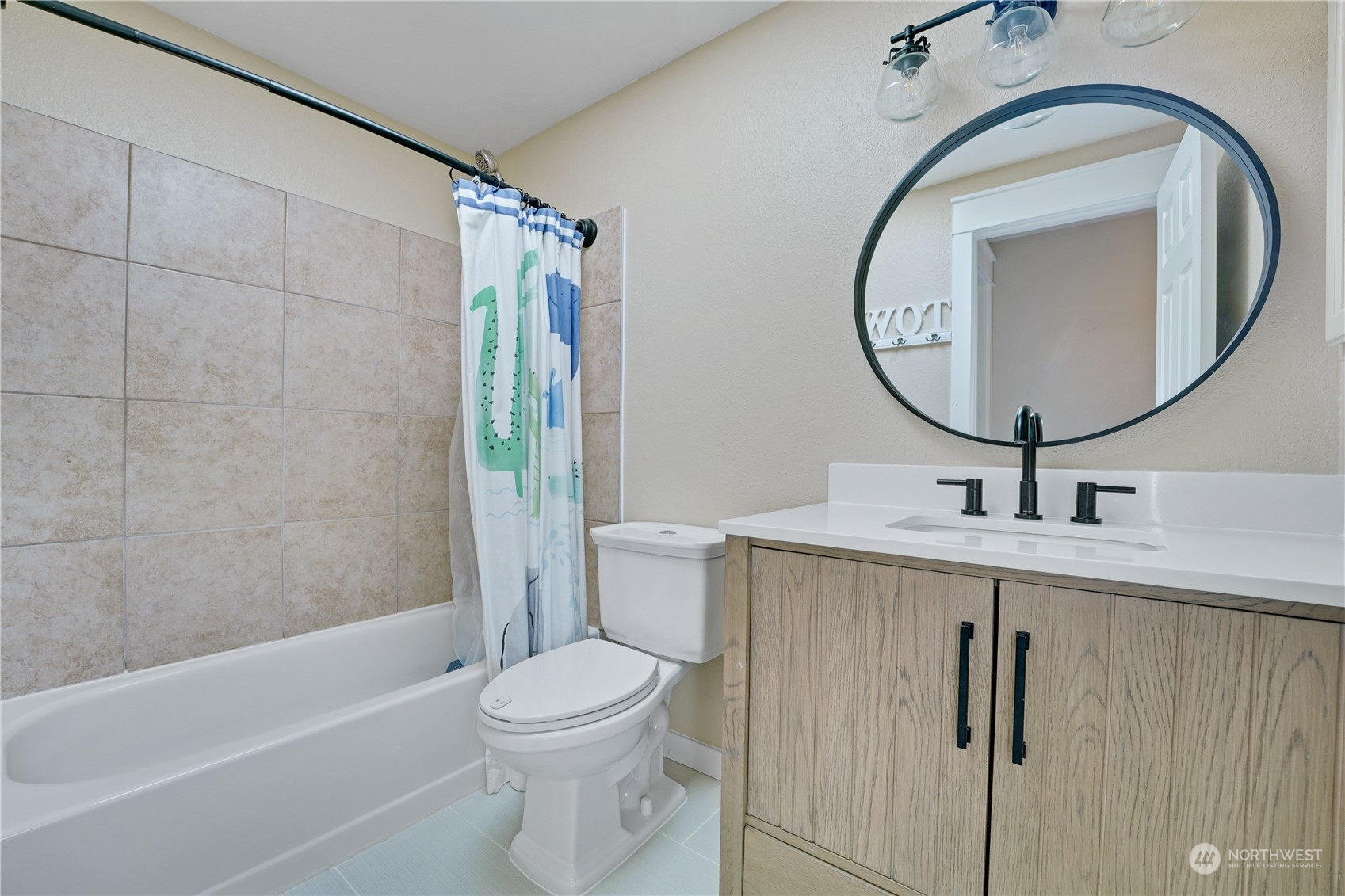 1410 220th Street Southwest Bothell, WA 98021 - Photo 21 of 25 a bathroom with a toilet sink vanity tub and mirror