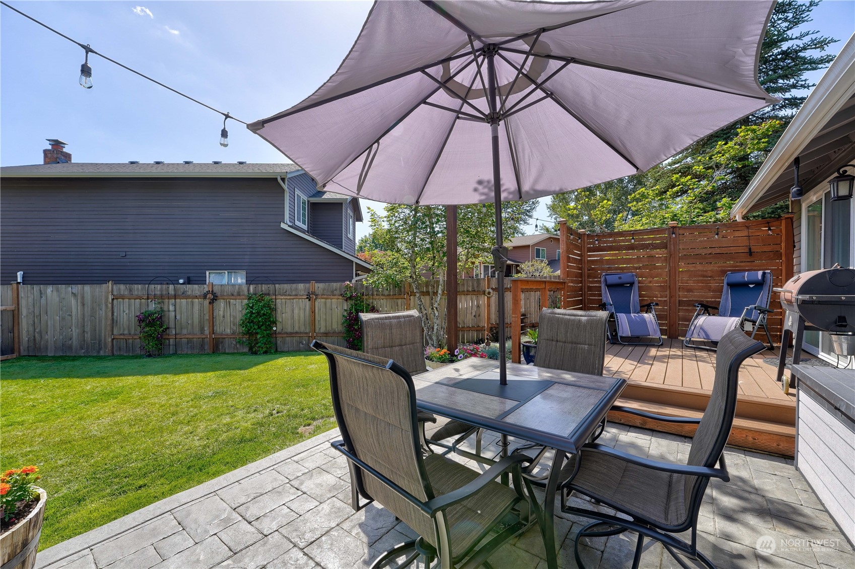 1410 220th Street Southwest Bothell, WA 98021 - Photo 6 of 25 a view of a patio with table and chairs under an umbrella