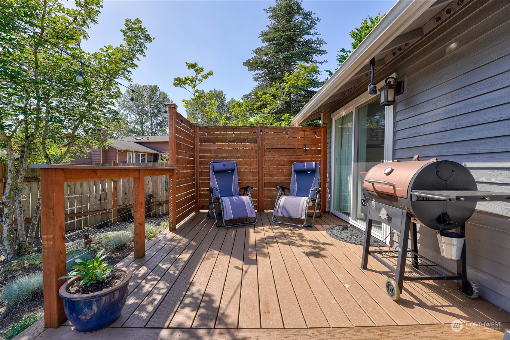 1410 220th Street Southwest Bothell, WA 98021 - Photo 8 of 25 a view of a patio with table and chairs potted plants with wooden floor and fence