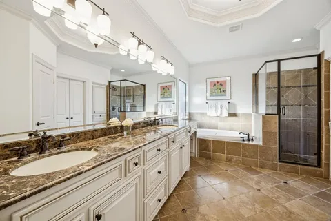 a spacious bathroom with a granite countertop sink mirror and bathtub