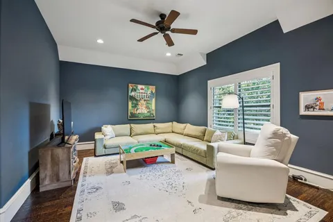 a living room with furniture a large window and a flat screen tv