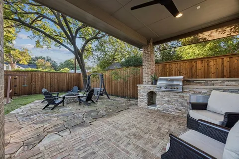 a backyard of a house with table and chairs