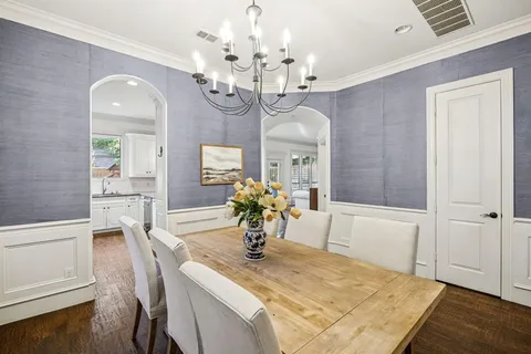 a view of a dining room with furniture and chandelier