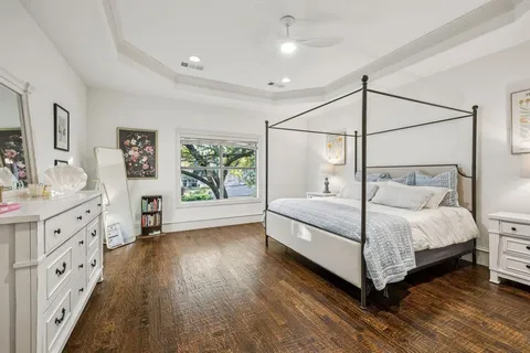 a bedroom with a large bed and a chandelier