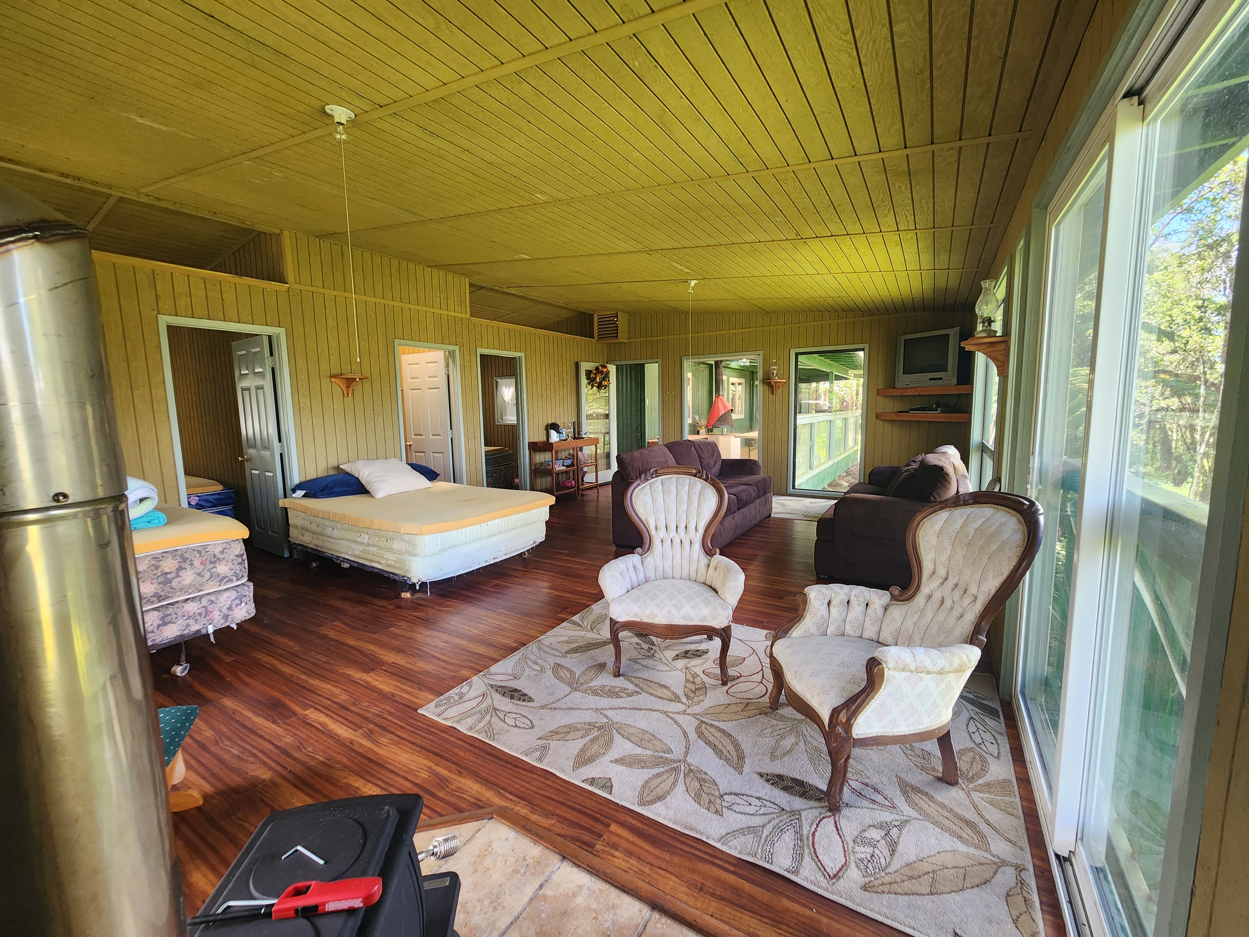 Mamalahoa Highway Captain Cook, HI 96704 - Photo 11 of 19 a living room with patio furniture and a large window