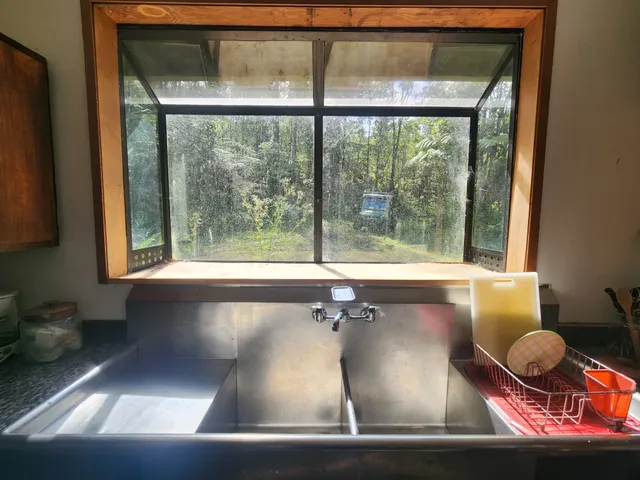 a living room with patio furniture and a large window