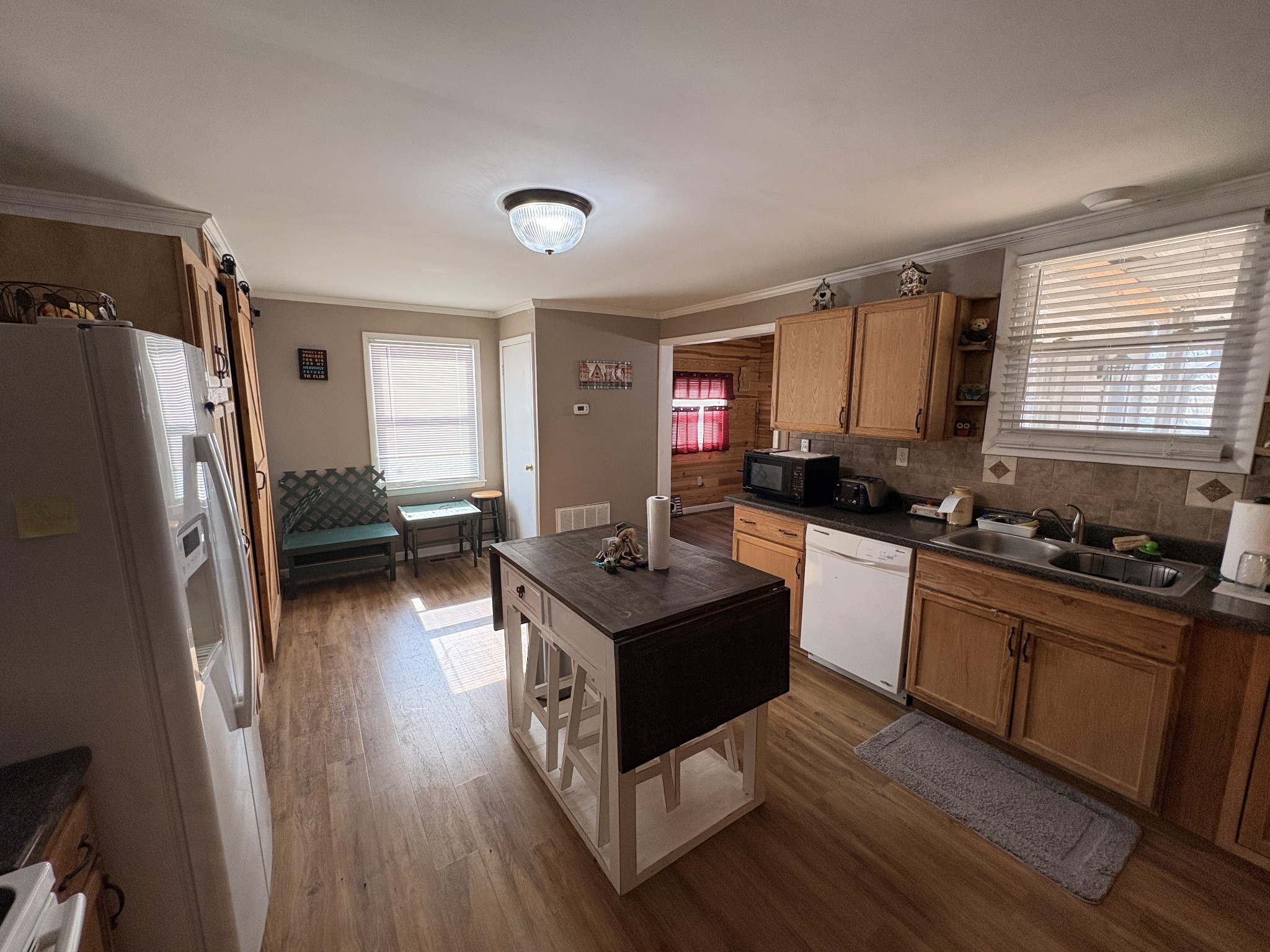 4454 Nancy Green Ridge Road Pulaski, TN 38478 - Photo 6 of 40 a kitchen with stainless steel appliances granite countertop a stove a sink dishwasher a refrigerator and a dining table with wooden floor