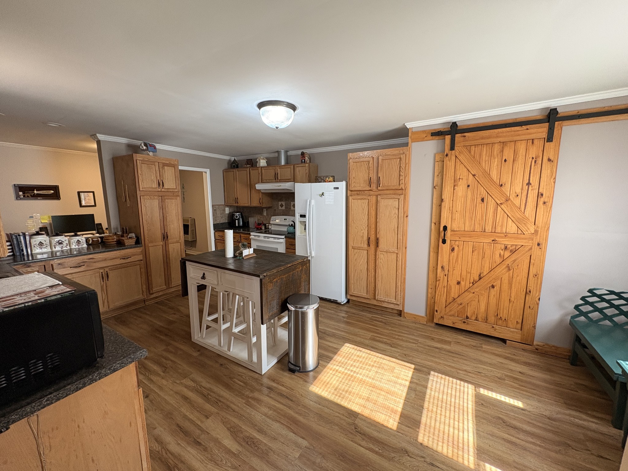 4454 Nancy Green Ridge Road Pulaski, TN 38478 - Photo 7 of 40 a kitchen with granite countertop a refrigerator cabinets and wooden floor