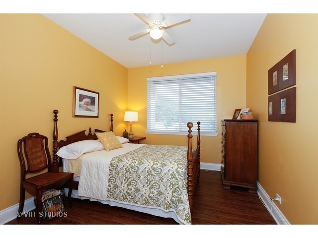 150 Hidden Pond Circle Aurora, IL 60504 - Photo 12 of 15 a bedroom with a bed and wooden floor
