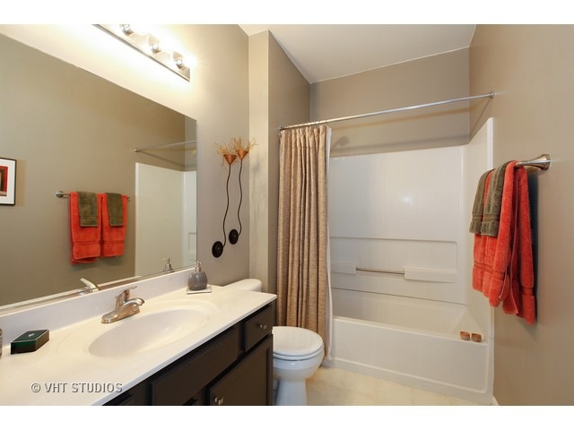 150 Hidden Pond Circle Aurora, IL 60504 - Photo 13 of 15 a bathroom with a sink and a mirror