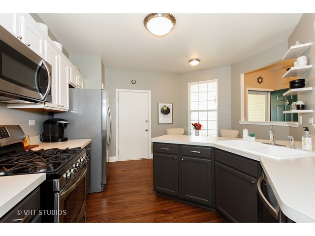 150 Hidden Pond Circle Aurora, IL 60504 - Photo 6 of 15 a kitchen with stainless steel appliances a sink stove and microwave