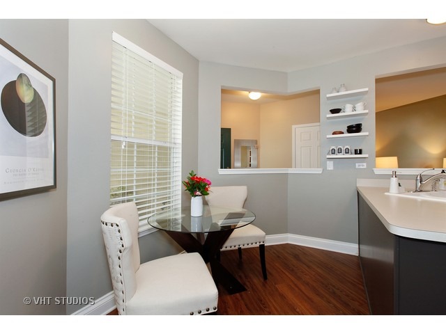 150 Hidden Pond Circle Aurora, IL 60504 - Photo 8 of 15 a living room with furniture and a flat screen tv