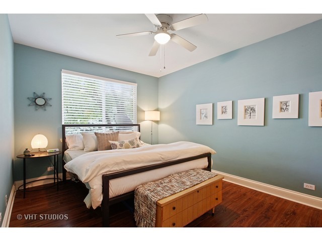 150 Hidden Pond Circle Aurora, IL 60504 - Photo 10 of 15 a bedroom with a bed and a chandelier