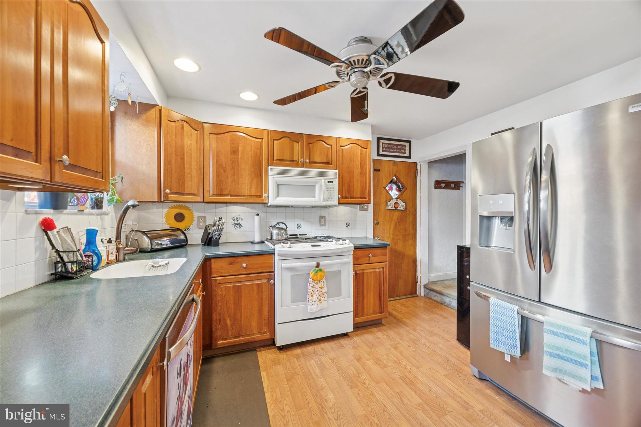 4410 School Lane Drexel Hill, PA 19026 - Photo 12 of 27 a kitchen with stainless steel appliances sink stove refrigerator and cabinets