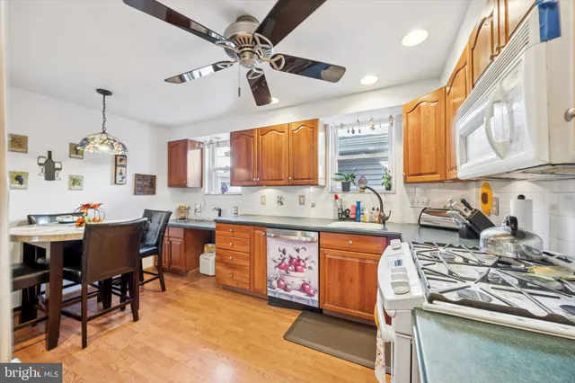 a large kitchen with stainless steel appliances granite countertop a sink stove and refrigerator