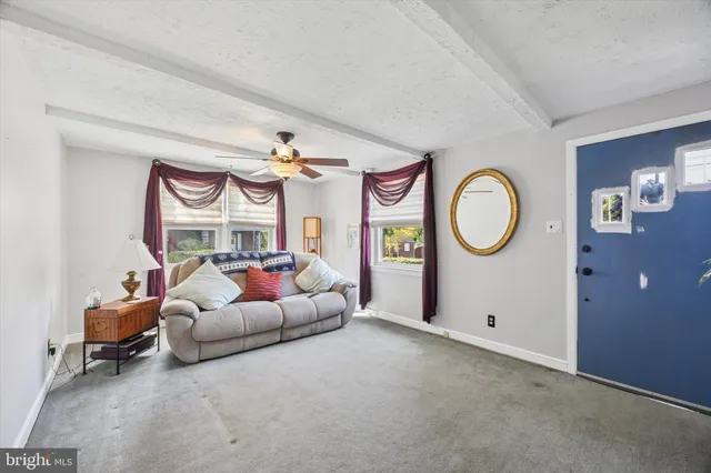 a living room with furniture and a mirror